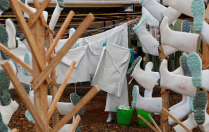 A healthcare worker holds washed parts of protective gear at a transit centre in Beni, North Kivu Province of Democratic Republic of Congo, December 15, 2018. Photo by Goran Tomasevic/Reuters