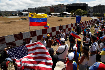 Supporters of the Venezuelan opposition leader Juan Guaido, who many nations have recognized as the country's rightful interim ruler, take part in a rally to demand President Nicolas Maduro to allow humanitarian aid to enter the country, outside of an Air Force base in Caracas, Venezuela on February 23, 2019. Photo by Carlos Garcia Rawlins/Reuters