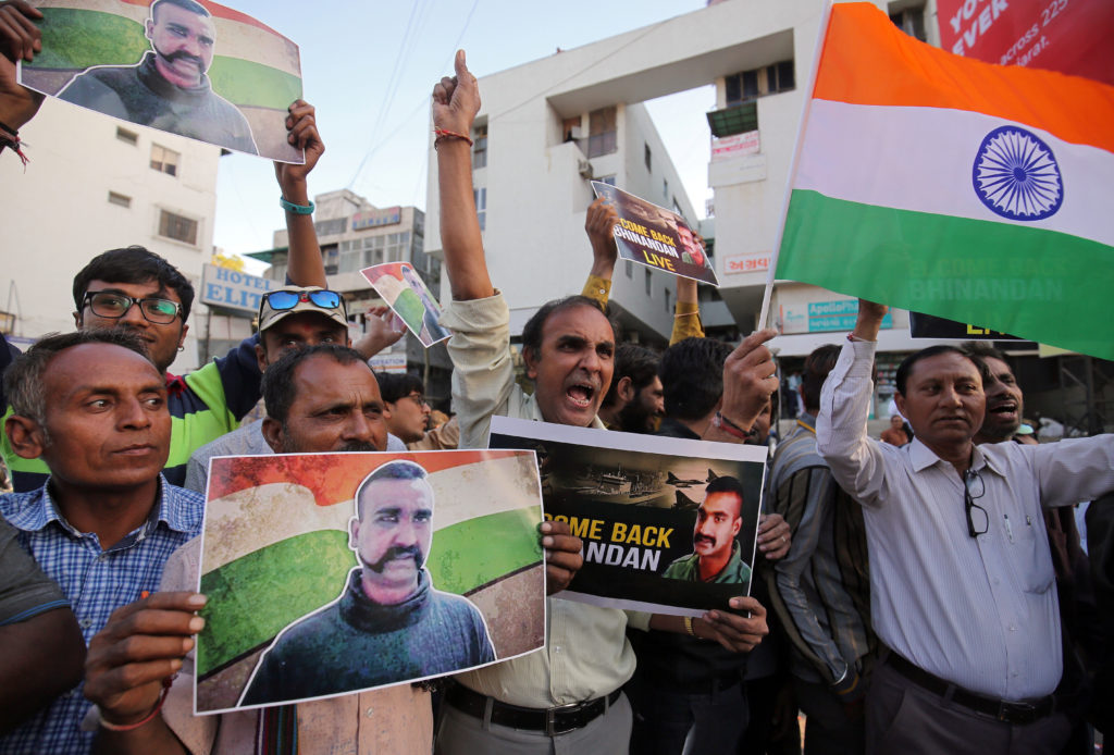 People celebrate before the release of Indian Air Force pilot, who was captured by Pakistan on Wednesday, in a street in A...