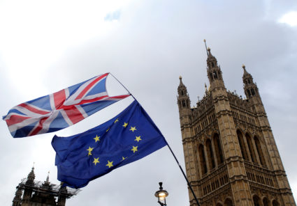 Flags flutter outside the Houses of Parliament on March 13, 2019. Photo by Tom Jacobs/Reuters