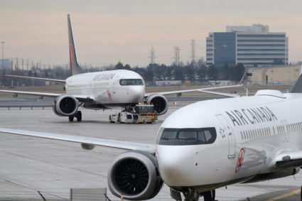 An Air Canada Boeing 737 MAX 8 aircraft is being towed in as another Air Canada Boeing 737 MAX 8 aircraft is seen on the ground at Toronto Pearson International Airport in Toronto, Ontario on March 13, 2019. Photo by Chris Helgren/Reuters