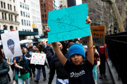 Students hold banners and placards during a demonstration against climate change in New York. Shannon Stapleton/Reuters