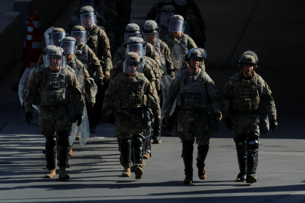 U.S. Military troops return from a test deployment with U.S. Customs and Border Protection agents after conducting a large...