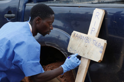 A Congolese red cross worker writes on a cross the name of Congolese woman Kahambu Tulirwaho who died of Ebola, before a burial service at a cemetery in Butembo in the Democratic Republic of Congo, March 28, 2019. Photo by Baz Ratner/Reuters