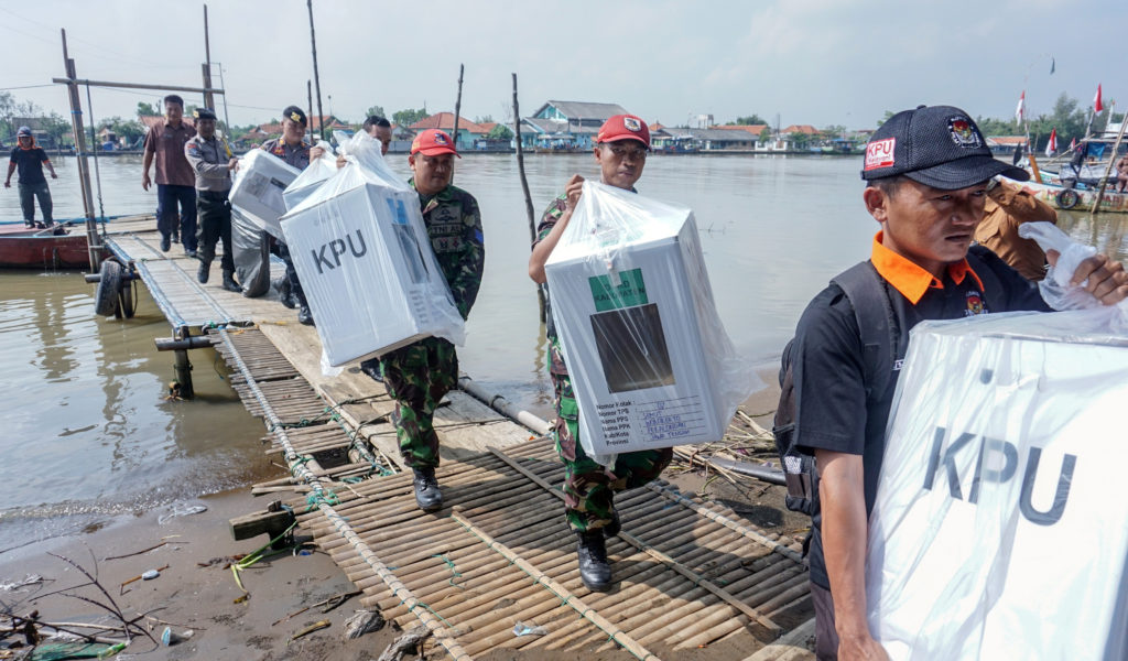 Officials carry election materials to be distributed in Pekalongan, Central Java province, Indonesia, April 16, 2019. Phot...