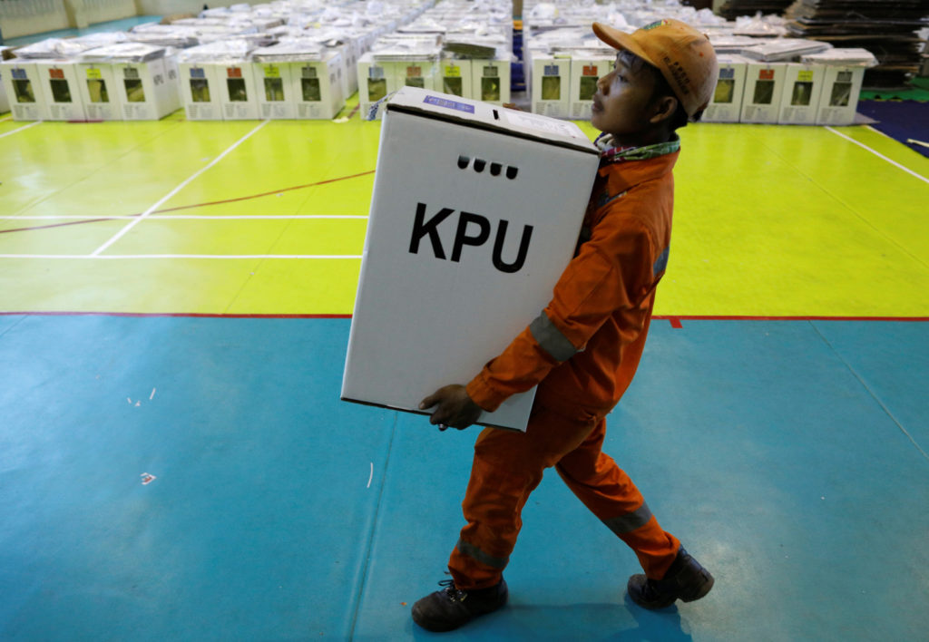 A worker prepares election materials to be distributed to polling stations at a sports hall in Jakarta, Indonesia on April...