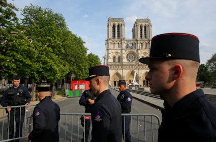 Members of Paris Fire Brigade enter the security perimeter to Notre Dame cathedral in Paris, France on April 18, 2019. Photo by Michel Euler/Pool via Reuters
