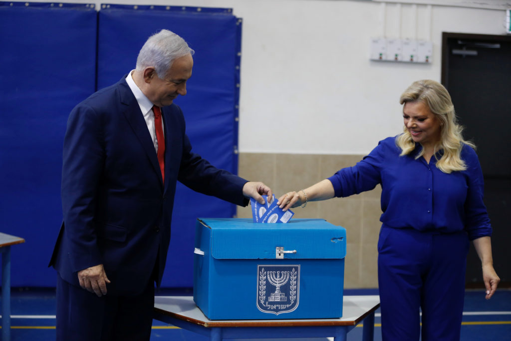 Israel's Prime Minister Benjamin Netanyahu casts his vote with his wife Sara during Israel's parliamentary election in Jer...