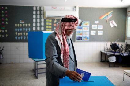 A Bedouin man casts his ballot as Israelis vote in a parliamentary election, at a polling station in the city of Rahat in Israel's southern Negev Desert. Photo by Amir Cohen/Reuters