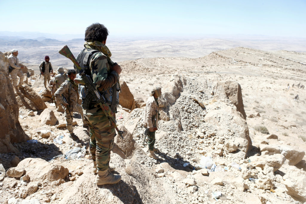 Yemeni soldiers stand on their position on a mountain on the frontline of fighting with Houthis in Nihem area, near Sanaa,...