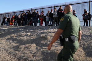 A group of Central American migrants surrenders to U.S. Border Patrol Agent Jose Martinez south of the U.S.-Mexico border fence in El Paso, Texas, March 6, 2019. The Department of Homeland Security has reassigned hundreds of agents away from ports of entry to handle immigrants coming across the border. Photo by Lucy Nicholson/Reuters