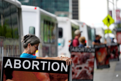 Anti-abortion protestors holding what they said were photos of abortions stand outside the building where new organizations are working at the Republican Presidential Convention in Cleveland July 14, 2016. Photo by REUTERS/Rick Wilking
