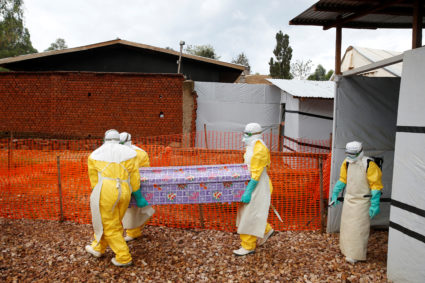 Health workers dressed in Ebola protective suits carry a coffin with the body of Congolese woman Kahambu Tulirwaho, who died of Ebola, as it is transported for a burial from the Ebola treatment centre in Butembo, in the Democratic Republic of Congo, March 28, 2019. Photo by Baz Ratner/Reuters