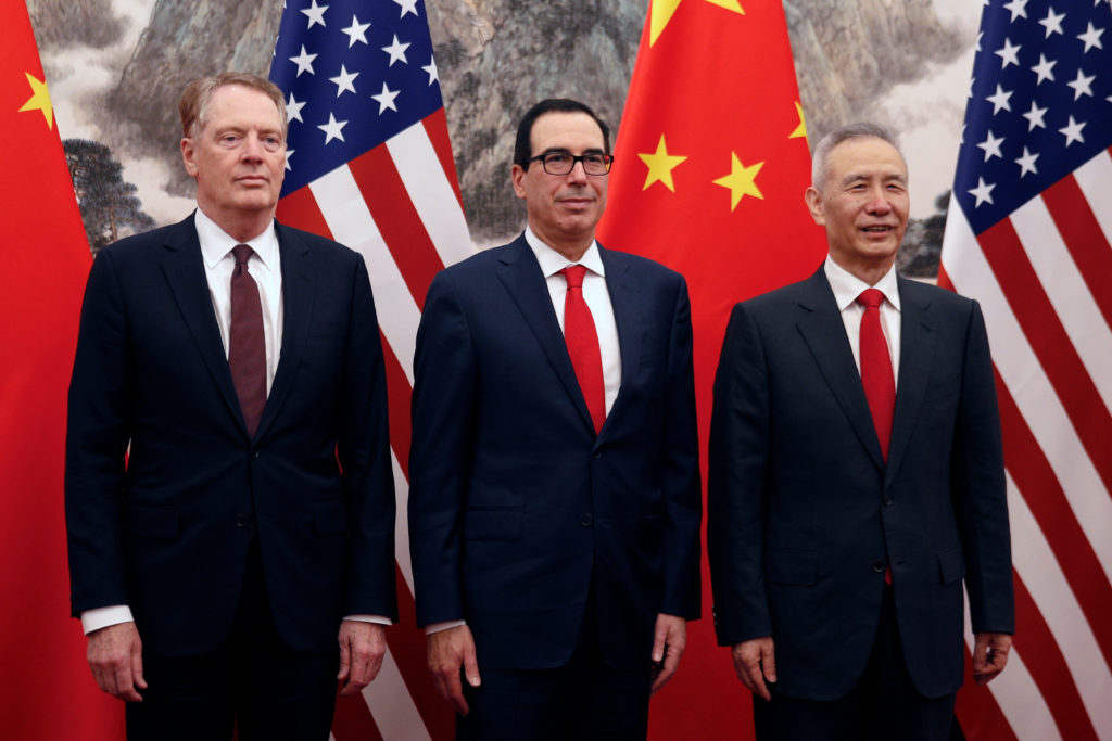 Chinese Vice Premier Liu He, right, poses with U.S. Treasury Secretary Steven Mnuchin, center, and U.S. Trade Representati...