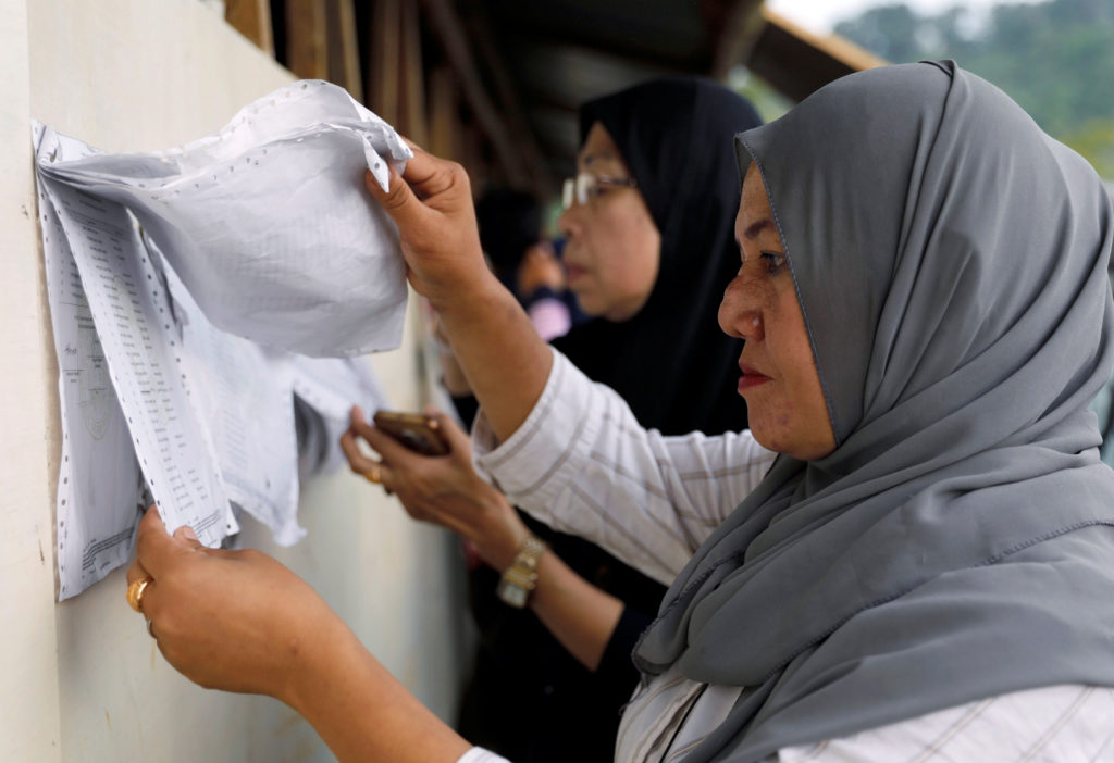 Voters look for their names from a list outside makeshift polling precints in Marawi City, Lanao Del Sur province, Philipp...