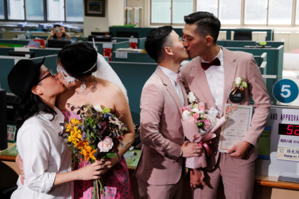 Couples Shane Lin (R) and Marc Yuan, and Cynical Chick (L) and Li Ying-Chien, kiss after registering for same-sex marriage at the Household Registration Office in Shinyi District in Taipei, Taiwan. Photo by Tyrone Siu/Reuters