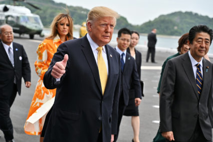 Trump returns to U.S. political feuds after 4-day trip to Japan