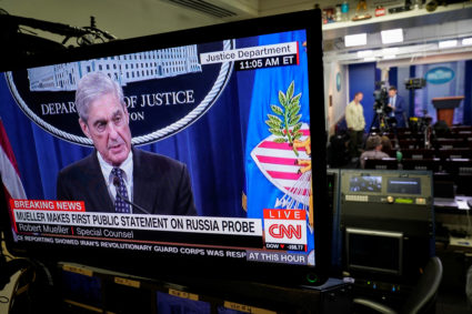 Special counsel Robert Mueller is shown speaking on a monitor about his report into Russia's role in the 2016 election and any potential wrong doing by President Donald Trump in the Briefing Room of the White House in Washington, D.C. Photo by Joshua Roberts/Reuters