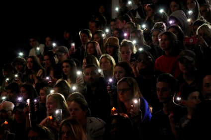 People hold up the phone lights during a moment of silence at a vigil for the victims of the shooting at the Science, Technology, Engineering and Math (STEM) School in Highlands Ranch, Colorado, U.S., May 8, 2019 as U.S. Sen. Michael Bennett (D-Co.) speaks. Photo by Rick Wilking/Reuters