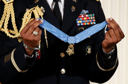 A military aide holds the Medal of Honor on July 31, 2017. Photo by Joshua Roberts/Reuters