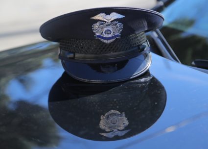 FILE PHOTO: A Los Angeles Police Department (LAPD) officer's cap rests on the hood of a patrol vehicle in Los Angeles, California, on March 4, 2018. Photo by Chris Helgren/Reuters