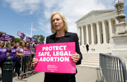 Democratic 2020 U.S. presidential candidate and U.S. Senator Kirsten Gillibrand (D-NY) holds a protest sign in front of a crowd of abortion rights demonstrators during a rally outside the U.S. Supreme Court in Washington, on May 21, 2019. Photo by Kevin Lamarque/Reuters
