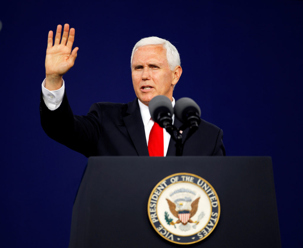 Vice President Mike Pence waves to the audience at the end of his commencement speech at Liberty University in Lynchburg, ...