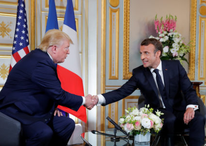French President Emmanuel Macron and U.S. President Donald Trump shake hands a during bilateral meeting in Caen, Normandy, France, June 6, 2019. Photo by Carlos Barria/Reuters