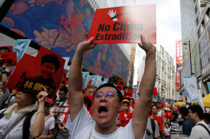 A demonstrator holds up a sign during a protest to demand authorities scrap a proposed extradition bill with China, in Hong Kong. Photo taken June 9, 2019, by Thomas Peter/Reuters