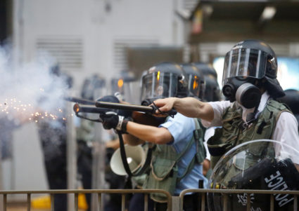 Police officers fire tear gas during a demonstration against a proposed extradition bill in Hong Kong, China on June 12, 2019. Photo by Thomas Peter/Reuters