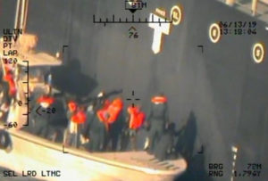 A U.S. military image released by the Pentagon in Washington on June 17, shows personnel that the Pentagon says are members of the Islamic Revolutionary Guard Corps Navy removing an unexploded limpet mine from a Japanese owned commercial motor tanker. Photo by U.S. Navy via Reuters