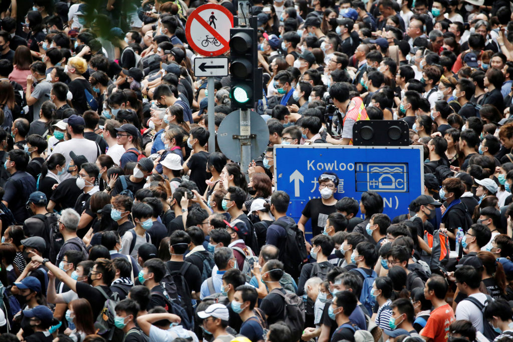 People protest outside police headquarters, demanding Hong Kong’s leaders to step down and withdraw the extradition bill, ...