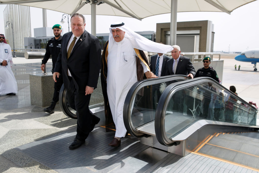 Secretary of State Mike Pompeo comes off an escalator with Saudi Foreign Minister Ibrahim Abdulaziz Al-Assaf, as Pompeo ar...