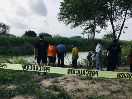 Authorities stand behind warning tape along the Rio Grande bank where the bodies of Salvadoran migrant Oscar Alberto Martínez Ramírez and his nearly 2-year-old daughter Valeria were found, in Matamoros, Mexico, Monday, June 24, 2019, after they drowned trying to cross the river to Brownsville, Texas. Martinez' wife, Tania told Mexican authorities she watched her husband and child disappear in the strong current. AP Photo/Julia Le Duc