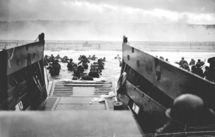 U.S. troops wade ashore from a Coast Guard landing craft at Omaha Beach during the Normandy D-Day landings near Vierville sur Mer, France, on June 6, 1944 in this handout photo provided by the U.S. National Archives. Photo by Robert F. Sargent/U.S. National Archives/Handout via Reuters
