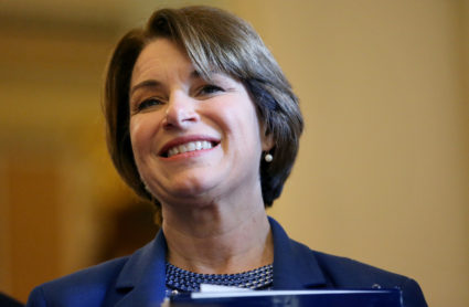 U.S. Sen. Amy Klobuchar listens as Democratic Leader Schumer speaks to the media on Capitol Hill in Washington, on June 18, 2019. Photo by Leah Millis/Reuters