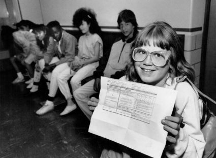Sixth grader Ginger Taylor shows proof of Immunization against the measles in 1989. Photo By Glen Martin/The Denver Post via Getty Images