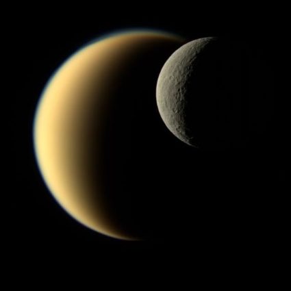Saturn's icy moon Rhea passes in front of Titan as seen by NASA's Cassini spacecraft in 2009. Image by NASA/JPL-Caltech/Space Science Institute