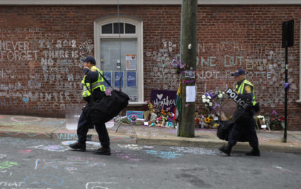 Law enforcement walks past a memorial to Heather Heyer ahead of the one year anniversary of 2017 Charlottesville "Unite the Right" protests, in Charlottesville, Virginia, on August 11, 2018. Photo by Jim Urquhart/Reuters