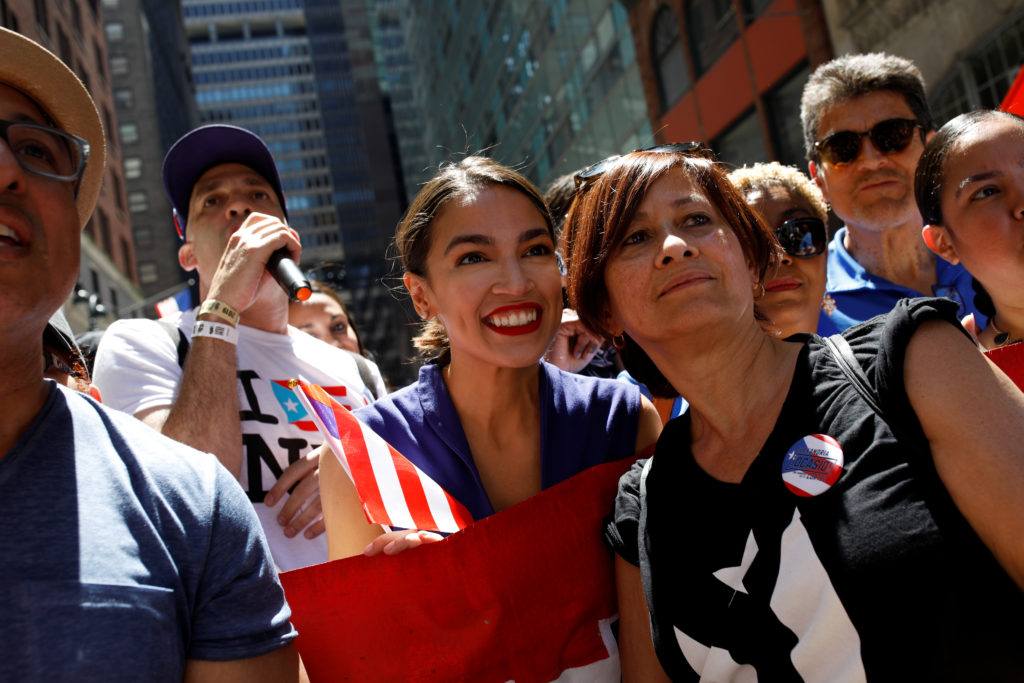 Representative Alexandria Ocasio-Cortez poses for a portrait with marchers at the annual Puerto Rican Day Parade in Manhat...