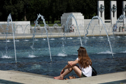 A woman cools off at a fountain during hot weather at the Word War Two Memorial in Washington, DC, on June 27, 2019. Photo by Yuri Gripas/Reuters