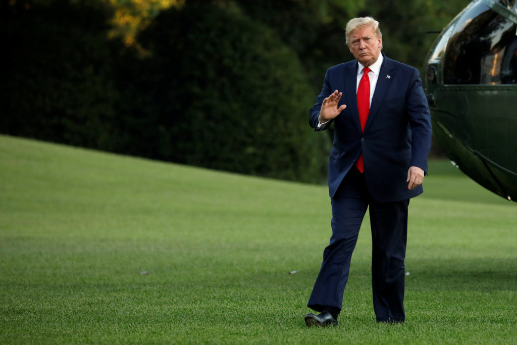 President Donald Trump waves as he as walks on the South Lawn of the White House upon his return to Washington from South ...