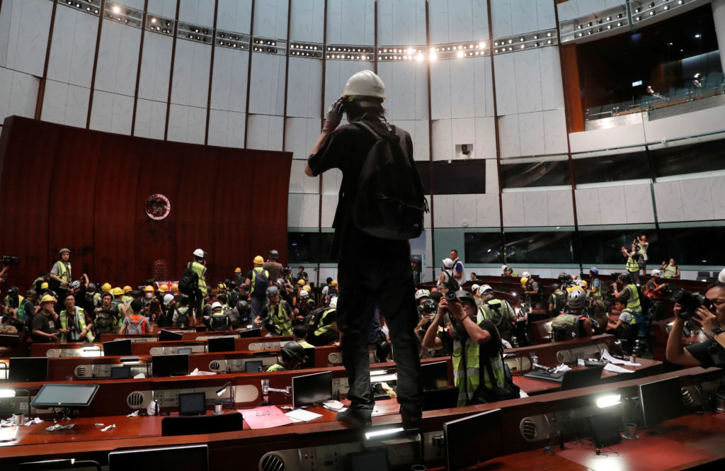 Protesters are seen inside a chamber after they broke into the Legislative Council building during the anniversary of Hong...