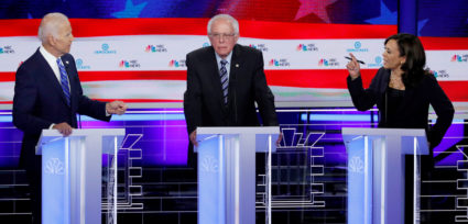 FILE PHOTO: Former Vice President Joe Biden and Senator Kamala Harris debate racial issues as Senator Bernie Sanders listens during the second night of the first U.S. Democratic presidential candidates 2020 election debate in Miami, Florida, on June 27, 2019. Photo by Mike Segar/Reuters