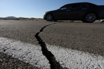 A car passes over a fissure that opened on a highway during a powerful earthquake that struck Southern California, near the city of Ridgecrest, California, U.S., July 4, 2019. Photo by REUTERS/David McNew