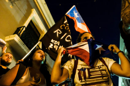 Demonstrators chant and wave Puerto Rican flags during the fourth day of protest calling for the resignation of Governor Ricardo Rossello in San Juan, Puerto Rico on July 16, 2019. Photo by Gabriella N. Baez/Reuters