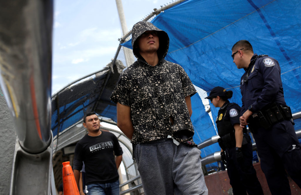 Mexican migrants deported from the U.S. walk towards Mexico at Paso del Norte International border bridge, in this picture...