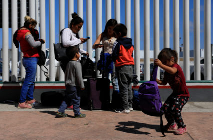 People wait to apply for asylum in the United States outside the El Chaparral border in Tijuana, Mexico on July 19, 2019 Photo by Carlos Jasso/Reuters
