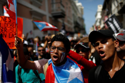 Men shout during ongoing protests calling for the resignation of Governor Ricardo Rossello in San Juan, Puerto Rico on July 20, 2019. Photo by Marco Bello/Reuters