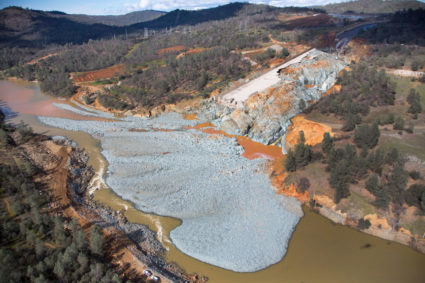 An aerial view of the damaged Oroville Dam spillway in California, and the debris field just below, in February 2017. Photo by California Department of Water Resources